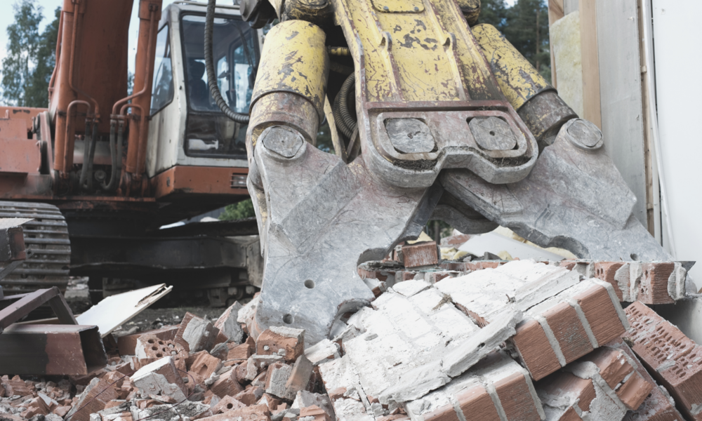 Bagger im Bauschutt nach dem Abriss
